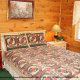 Rest well in this country furnished bedroom in cabin 102 (Barbaras View), in Pigeon Forge, Tennessee. 