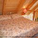 Rest well in this cozy haven of a bedroom in cabin 103 (Knotty Pine), in Pigeon Forge, Tennessee. 