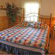 Sleep peacefully in this attractive bedroom in cabin 103 (Knotty Pine), in Pigeon Forge, Tennessee. 