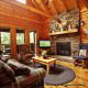 Living room with vaulted ceiling and fireplace in cabin 104 (Rens Nest) at Eagles Ridge Resort at Pigeon Forge, Tennessee.