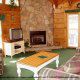 Large living room with a stone fireplace in Cabin 14, (The View), in Pigeon Forge, Tennessee.