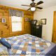 Bedroom with TV Set in Cabin 15 (A Bears Life) at Eagles Ridge Resort at Pigeon Forge, Tennessee.