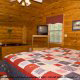 Bedroom View with TV Set of Cabin 17 (Perfect Getaway) at Eagles Ridge Resort at Pigeon Forge, Tennessee.