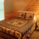 Bedroom with Night Stand in Cabin 20 (Eagles Roost) at Eagles Ridge Resort at Pigeon Forge, Tennessee.