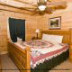 Bedroom View with Night Stand of Cabin 205 (Love Nest) at Eagles Ridge Resort at Pigeon Forge, Tennessee.