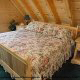Bedroom with King Size Bed in Cabin 215 (Red Bird Haven) at Eagles Ridge Resort at Pigeon Forge, Tennessee.