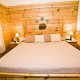 Bedroom with King Size Bed in Cabin 223 (Youngs Hideaway) at Eagles Ridge Resort at Pigeon Forge, Tennessee.