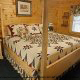 Bedroom with King Size Bed in Cabin 230 (Smoky Mountain Paradise) at Eagles Ridge Resort at Pigeon Forge, Tennessee.