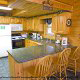 Large country kitchen with bar in cabin 241 (Eagle Crest Lodge) at Eagles Ridge Resort at Pigeon Forge, Tennessee.