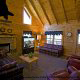 Large living room with vaulted ceiling and fireplace in cabin 241 (Eagle Crest Lodge) at Eagles Ridge Resort at Pigeon Forge, Tennessee.