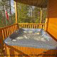 Hot tub on porch in cabin 244 (Blackhawk Hideaway) , in Pigeon Forge, Tennessee.