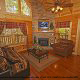 Living room with vaulted ceiling and fire place in cabin 244 (Blackhawk Hideaway) , in Pigeon Forge, Tennessee.