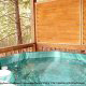 Deck with hot tub in cabin 254 (Hibernation Hideaway) at Eagles Ridge Resort at Pigeon Forge, Tennessee.