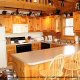 Country kitchen with bar in cabin 254 (Hibernation Hideaway) at Eagles Ridge Resort at Pigeon Forge, Tennessee.