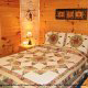 Country bedroom in cabin 255 (Happy Trails) at Eagles Ridge Resort at Pigeon Forge, Tennessee.