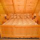 Bedroom with Queen Size Bed in Cabin 256 (Smoky Mountain Top) at Eagles Ridge Resort at Pigeon Forge, Tennessee.