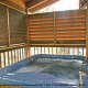 Deck with hot tub in cabin 258 (Sweet Memories) at Eagles Ridge Resort at Pigeon Forge, Tennessee.