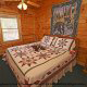Cozy Pine furnished bedroom in Cabin 27, (Bear Naked), in Pigeon Forge, Tennessee.