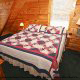 Bedroom with a country feel in Cabin 27, (Bear Naked), in Pigeon Forge, Tennessee.