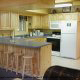Country kitchen with bar in cabin 298 (Renewed Spirit) at Eagles Ridge Resort at Pigeon Forge, Tennessee.