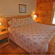 Bedroom with King Size Bed in Cabin 299 (Possum Hollow) at Eagles Ridge Resort at Pigeon Forge, Tennessee.