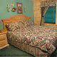 Country bedroom with a window in cabin 30 (Mountain Refuge), in Pigeon Forge, Tennessee.
