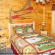 Country bedroom in cabin 305 (Bear Right In) at Eagles Ridge Resort at Pigeon Forge, Tennessee.