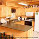 Country kitchen with bar in cabin 309 (Georges) at Eagles Ridge Resort at Pigeon Forge, Tennessee.