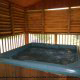 Submerge yourself with a glass of wine or a steaming cup of herbal tea in this hot tub in cabin 31 (Grandma And Grandpas Place), in Pigeon Forge, Tennessee.
