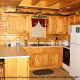 Country kitchen with bar in cabin 312 (Bear Mountain Memories) at Eagles Ridge Resort at Pigeon Forge, Tennessee.