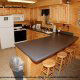 Country Kitchen with bar in cabin 313 (Crosswinds) at Eagles Ridge Resort at Pigeon Forge, Tennessee.