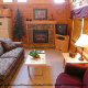 Living room with vaulted ceiling and fire place in cabin 314 (Yall Come Back Now Ya Hear) , in Pigeon Forge, Tennessee.
