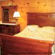 Bedroom with a sleigh bed to curl up in cabin 32 (Country Delight), in Pigeon Forge, Tennessee.