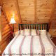 Cozy country bedroom to sleep in comfort in cabin 32 (Country Delight), in Pigeon Forge, Tennessee.