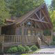 Front view of  cabin 40 nestled in the woods foliage (Bear Pause), in Pigeon Forge, Tennessee.