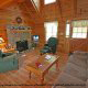 Living room with vaulted ceilings and fireplace in cabin 41 (Tennessee Mountain Memories) , in Pigeon Forge, Tennessee.