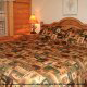 Country Bedroom with King Size Bed in Cabin 45 (Critters Nest) at Eagles Ridge Resort at Pigeon Forge, Tennessee.