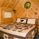 Bedroom View with Night Stand of Cabin 49 (Dream View) at Eagles Ridge Resort at Pigeon Forge, Tennessee.
