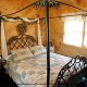 This bedroom will entice anyone into a restful sleep with its beautiful canopy bed in cabin 50 (Creekside), in Pigeon Forge, Tennessee.
