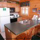 This kitchen has a bit of modern decor and country furnishings in cabin 50 (Creekside), in Pigeon Forge, Tennessee.