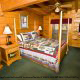Nature is brought in doors to this large beautifully decorated bedroom in cabin 51 (Natures Grace Retreat), in Pigeon Forge, Tennessee.