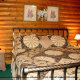 This bedroom invites you in for a well rested sleep in cabin 54 (Mountain Majesty), in Pigeon Forge, Tennessee.