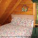 Bedroom with Round Table in Cabin 56 (Mountain High) at Eagles Ridge Resort at Pigeon Forge, Tennessee.