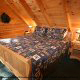Bedroom with King Size Bed in Cabin 6 (On Eagles Wings) at Eagles Ridge Resort at Pigeon Forge, Tennessee.
