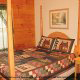 Curl up in this bedroom with this beautiful poster bed in cabin 65 (Eagles Point), in Pigeon Forge, Tennessee.