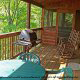 Have a barbecue or play some card on this porch in cabin 75 (Palmetto Place), in Pigeon Forge, Tennessee.