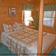 Feel the enchantment of sleeping in this country bedroom in cabin 75 (Palmetto Place), in Pigeon Forge, Tennessee.