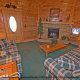 Warm your toes by the fire place in the den in cabin 75 (Palmetto Place), in Pigeon Forge, Tennessee.