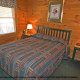 Curl up in this quaint country bedroom in cabin 76 (Bear Tracks), in Pigeon Forge, Tennessee. 