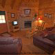 This living room has the added touch of a fire place to enjoy in cabin 76 (Bear Tracks), in Pigeon Forge, Tennessee. 